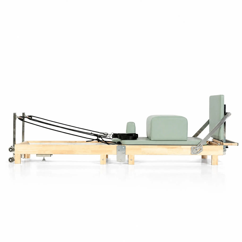 Foldable Maple Pilates Reformer with Sage Green Upholstery and Upright Storage