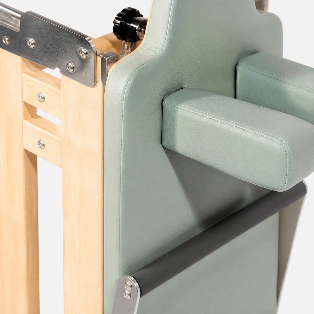 Foldable Maple Pilates Reformer with Sage Green Upholstery and Upright Storage